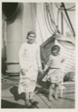 Image of Eskimo [Inuit] woman and child standing on mail boat
